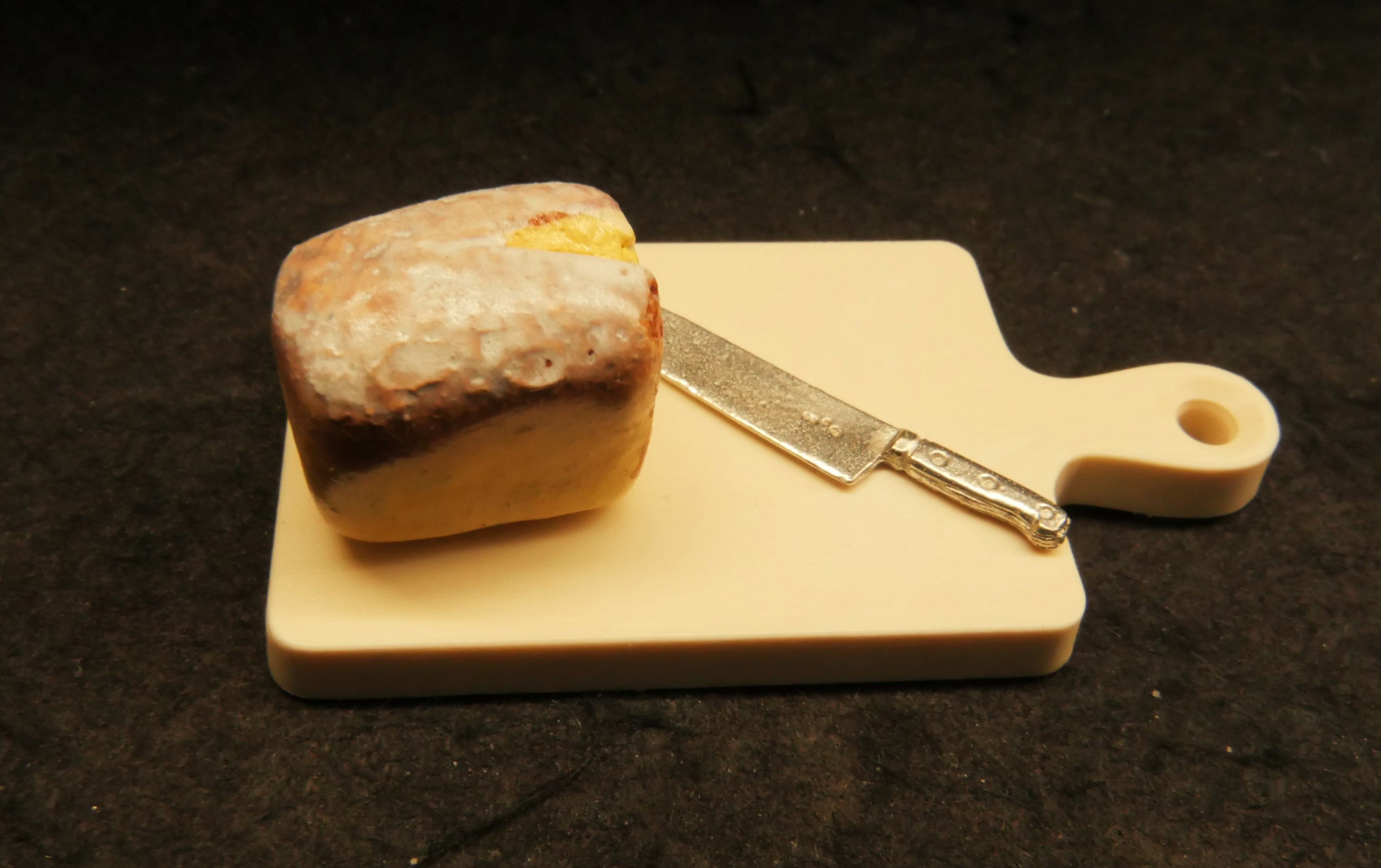 Breadboard loaf of bread and bread knife